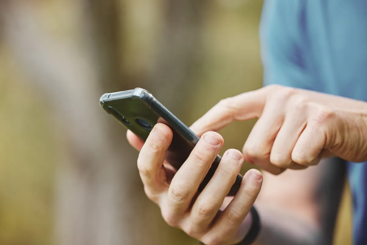 Hands texting on a smartphone