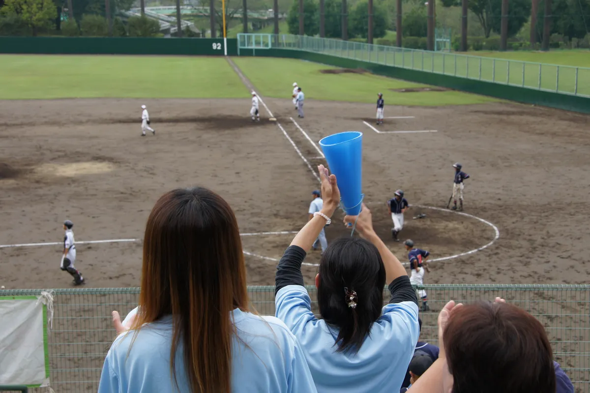 Parents cheering at a youth baseball game